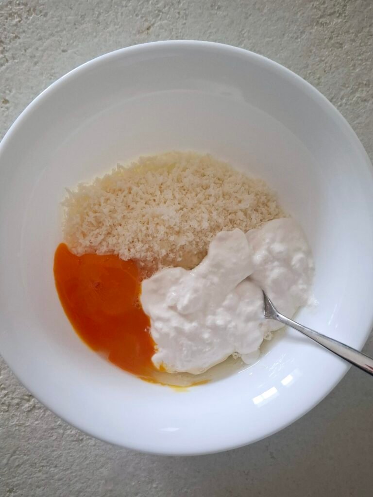 Uovo parmigiano e panna in una ciotola